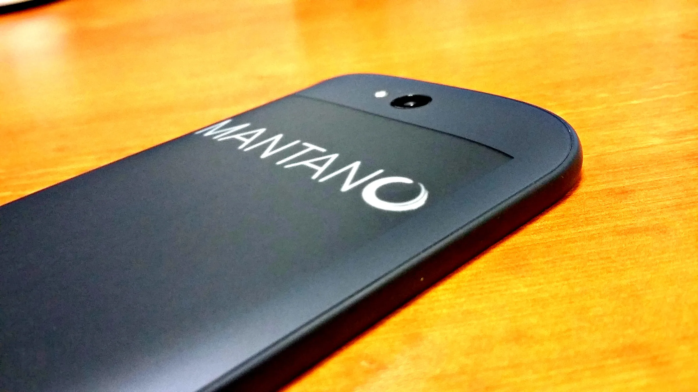 The back of the YotaPhone, its electronic-paper screen showing the Mantano logo